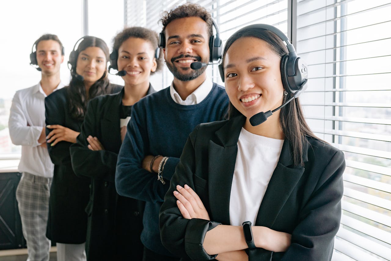 gallery-1 A diverse group of smiling call center agents in an office setting.